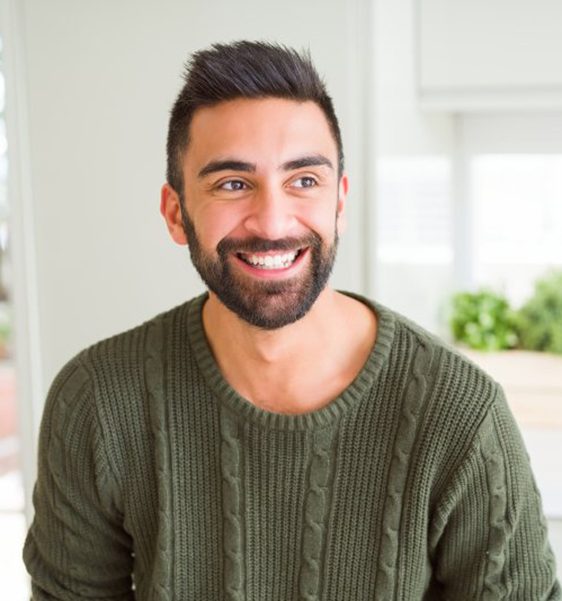 a man in a green shirt smiling