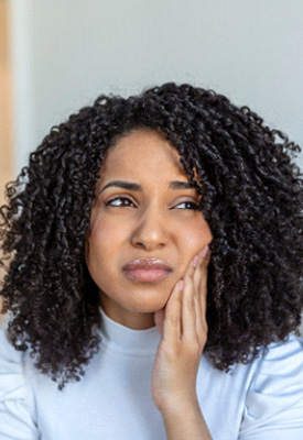 Woman experiencing toothache at home