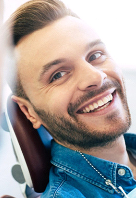 Man with straight teeth smiling at dentist