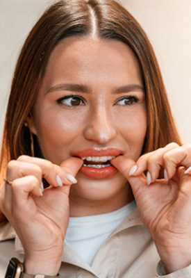 Patient putting clear aligners on in office